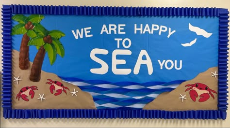 Ocean themed bulletin board with saying ‘We are happy to Sea you’ palm trees, mini crabs and craft paper islands. Welcome Aboard Bulletin Board, Sailing Bulletin Board Ideas, Happy To Sea You Bulletin Board, Aquarium Bulletin Board, Fishing Bulletin Board Ideas, Beach Themed Bulletin Board Ideas, Ocean Themed Bulletin Boards, Sailing Bulletin Board, Beach Bulletin Board Ideas