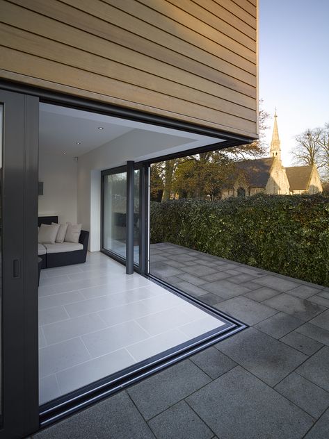 The aluminium sliding doors with removable corner post provides the perfect connection to the raised patio and garden beyond. Level threshold allows a seamless transition from the open plan kitchen, dining and living area. #slidingdoors #removablecornerpost #cornerglazing #levelthreshold #insideoutside #aluminiumslidingdoors #granddesigns #sunparadise Modern Conservatory, It Magazine, Stacker Doors, Sliding Door Window Treatments, Garage To Living Space, Door Window Treatments, Glass Doors Patio, Aluminium Sliding Doors, Raised Patio