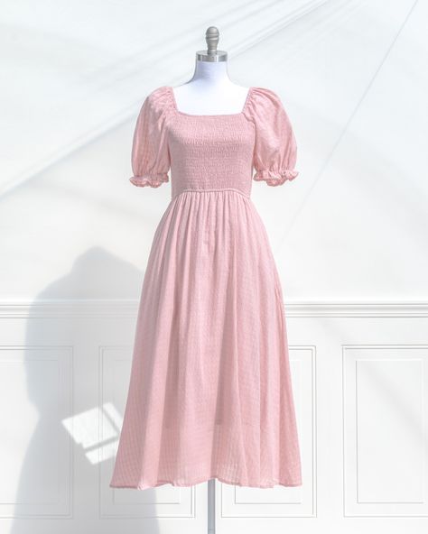 A classically romantic style, the feminine Lily of the Valley Dress is a dream in checked blush pink cotton, with a comfortable smocked elastic bodice, side-seam pockets, and tea-length skirt. Perfect for a picnic in the park, a day spent frolicking with friends, or just for lounging in with a cup of tea and your favorite novel ✨ 🏷️ French and feminine style pink dresses, Pink spring dresses, Puff sleeve pink dress, Romantic dress outfits for spring, Cottagecore style cotton dress #amantine ... Pink Spring Dresses, Spring Cottagecore, Tea Length Skirt, Cottagecore Style, Outfits For Spring, Picnic In The Park, Pink Spring, Pink And Silver, Pink Dresses