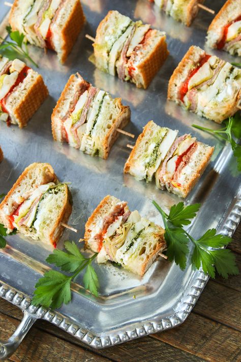 Densly packed with classic antipasti ingredients, this sandwich is vibrantly… Recept Sandwiches, Sandwich Bites, Tea Party Sandwiches, Tea Sandwiches Recipes, Party Sandwiches, Mini Sandwiches, Tea Party Food, Tea Sandwiches, Picnic Food