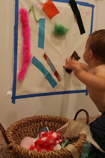 Contact paper and fabric scraps allow baby to pull pieces down and explore textures. Infant Provocations, Infant Curriculum, Sticky Wall, Treasure Basket, Infant Room, Heuristic Play, Infant Classroom, Daycare Room, Baby Sensory Play