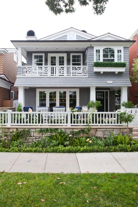 A cool color palette perfectly suits this beach home. Blue-gray siding is accented with thick white window frames, columns and trim. Covered porches on the first and second floor add depth to the exterior and create a space to enjoy the ocean air in any weather. Coastal Exterior, Retirement House, Gray House, Beach House Exterior, Hgtv Dream Home, Grey Exterior, Coastal Bedroom, Hamptons House, Beach Cottage Style