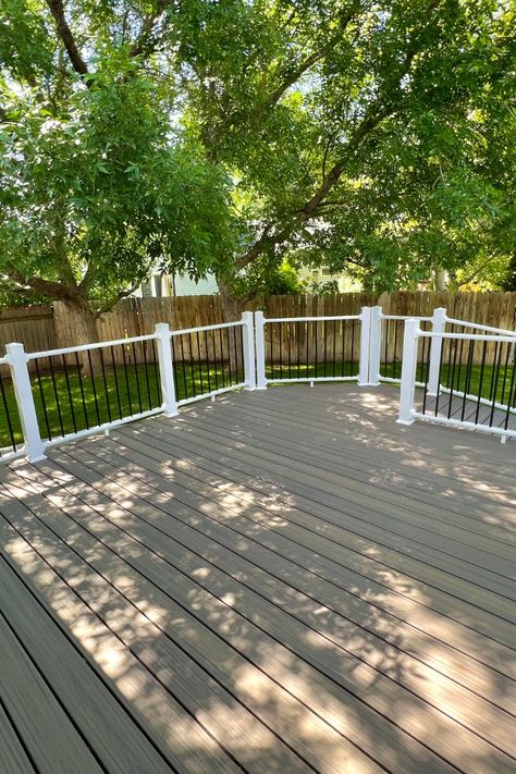 Pictured is a Rocky Harbor Trex Deck with a ramp and trex vertical skirting. The railing is white and black. Trex Rocky Harbor Decks, Rocky Harbor Trex Decking, Trex Rocky Harbor, Deck With Ramp, Trex Deck Ideas, Elevated Deck, Trex Composite Decking, Decking Options, Deck Fence