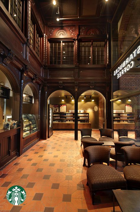 This Starbucks store is located in the historic central train station of Copenhagen. The original architectural detail remains untouched. The existing theatrical wooden arches serve as the face of the bar and beautifully frames the entire store. Starbucks Store Design, Starbucks Interior, Wooden Arches, Downtown Long Beach, Starbucks Locations, Starbucks Design, Starbucks Store, Menu Sign, Wooden Arch