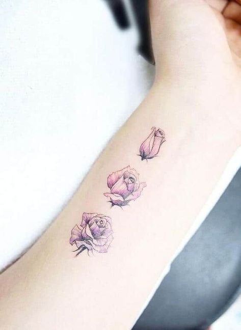 This tattoo has three miniature roses in different blooming stages, the first still closed, the second opening up and the third fully bloomed. Each is designed on the underside of the arm, just below the wrist. The roses also have similar light plum shading. #tattoofriday #tattoos #tattooart #tattoodesign #tattooidea Rose Tattoos For Women, Tato Henna, Roses Tattoo, Disney Tattoo, Wrist Tattoos For Women, Best Tattoo Designs, Tattoo Designs For Women, Design Tattoo, Trendy Tattoos