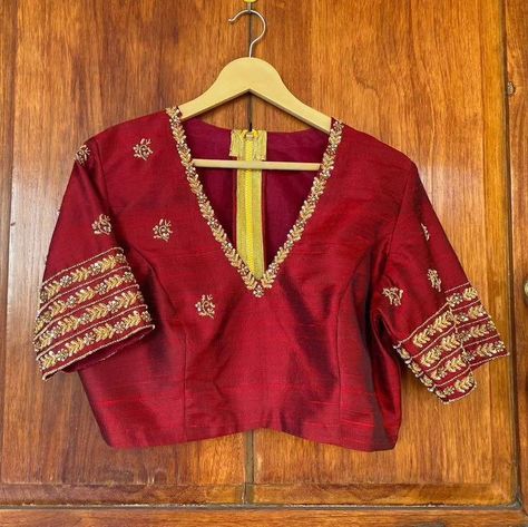 "Stunning Red Maggam Work Blouse at SM Designs! 🔥 Make a bold statement with our Red Maggam Work Blouse, designed for those who love elegance and tradition. Crafted from high-quality Half Pattu/Raw Silk fabric, this blouse features exquisite maggam embroidery, perfect for bridal wear, festive events, and celebrations. Elevate your ethnic wardrobe with this luxurious design, available in customizable colors and sizes. 🌸 Fabric: Half Pattu / Raw Silk 🌸 Dispatch: 4 days 🌸 Price: ₹ for 2400 uns... Maroon Color Maggam Work Blouse Designs, Black And Red Blouse Designs, Contrast Blouse Designs Latest, High Neck Work Blouses, V Neck Maggam Work Blouses, Blouse Zardosi Work Design, Maroon Maggam Work Blouse, V Neck Aari Work Blouse, Red Embroidered Blouse