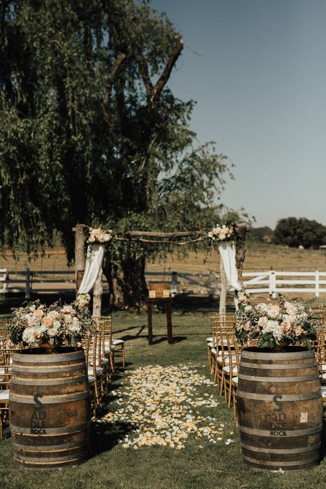 Outdoor Wedding Aisle Inspiration, Boho Ceremony Decor Aisle, Wine Barrel Ceremony Decor, Wine Barrel Wedding Aisle, Rustic Wedding Aisle Outdoor, Wedding Arch With Barrels, Wine Barrel Aisle Entrance, Barrels At Wedding Ceremony, Whiskey Barrel Wedding Decor Boho