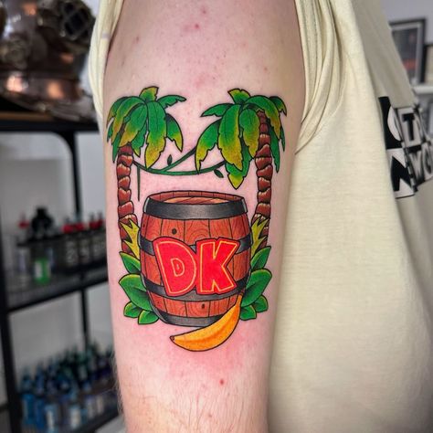 Is this Donkey Kong tattoo by Jordan Baker making anyone else really nostalgic or is it just us?  Created with #magnumtattoosupplies ❤️  #tattoo #tattooartist #tattoos #tattooart #tattoosupplies #tattooequipment #uktattooartist #uktattooartists #donkeykong #donkeykongtattoo #donkeykong64 #donkeykongcountry #nintendo #nintendotattoo #videogametattoo #gamingtattoo #gamertattoo #gamingnostalgia #uktattooist #colourtattoo Donkey Kong Tattoo, King Kong Tattoo Traditional, Donkey Kong Tattoo Ideas, Donkey Kong And Diddy Kong, Nintendo Tattoo, Donkey Kong Junior, Jordan Baker, Donkey Kong Game Retro, Video Game Tattoo