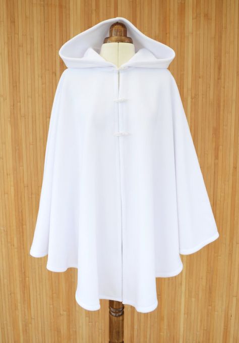 Envelop yourself in this pure white hooded cape, made from super soft fleece fabric and finished with three toggle buttons.  Standard size: fits 8 to 16 UK sizes/ 4 to 12 US sizes. Length 78cm / 31 inch Plus size: fits 18 to 22 UK sizes/ 14 to 18 US sizes. Length 86cm / 34 inch * If White Cape With Hood, Bridal Cloak, Wedding Dress Cover Up, Cape Tutorial, White Cloak, White Poncho, White Cape, Cape Cloak, Cashmere Cape