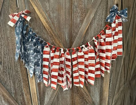 "Rustic USA Stars & Stripes Patriotic Decorative Fabric Garland- Red White Blue -  4th of July- Independence Day  Stars and Stripes fabric strips tied onto jute twine and accented with coordinating bows. the 36\" garland includes extra twine on eac end to make display and hanging easy. Each fabric strip has a drop of approximately 8\"." Vintage Independence Day, Vintage July 4th Decorations, Flag Display Ideas, 4th Of July Tree, Fouth Of July Crafts, 4th Of July Crafts, Patriotic Wall Decor, Americana Crafts, Flag Crafts