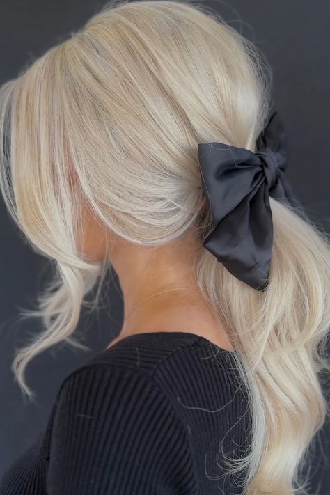 Woman with a messy low ponytail featuring side bangs and a black satin bow. Messy Low Ponytail, Ponytail With Side Bangs, Festive Hairstyles, Glamorous Christmas, Classic Updo, Bubble Ponytail, Bridal Hair Inspiration, Temporary Hair Color, Icy Blonde