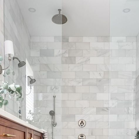 Kim Bui on Instagram: "Before and After bathroom photos. Many of you wanted to see details of the space and my friend, also encouraged me to post more still photos so here it is.  I can’t tell you how much I love it!! So glad the large bathtub in the middle of the room and sunken shower is gone. I’ll be sharing more details of what we did and what features I love throughout the week so stay tune and follow along 🩷. 

I would love to know what your favorite change/feature is. Let me know in the comments below. 

If you’re looking for sources, I linked as many items as I could in my LTK shop. Link in my bio or you can use this link here: https://liketk.it/4AB8p. 

Wall tiles: Casablanca Carrara Marble tiles 6x12 from @riadtile 

Faucet/Sconce Finishes: Polished Nickel
Hardware Finishes: Age Large Bathtub, Carrara Marble Tile, Polished Nickel Hardware, Stay Tune, Bathroom Photos, Nickel Hardware, Marble Tiles, Hardware Finishes, Carrara Marble