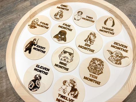 Star Wars themed monthly baby milestone marker signs. Each month has a different character or scene engraved on it. Perfect for a Star Wars loving family! Would be an adorable addition to your baby photos each month. Would also make a great gift for new parents and Star Wars lovers in your life! Includes month 1-12, tray in picture not included. #starwars #babymilestonesigns #milestonemarkers #monthlymilestone #starwarsbaby #disneybaby Milestone Markers, Monthly Baby, Baby Monthly Milestones, Disney Home Decor, Monthly Milestone, Baby Milestone Cards, Loving Family, Baby Milestone, Star Wars Baby