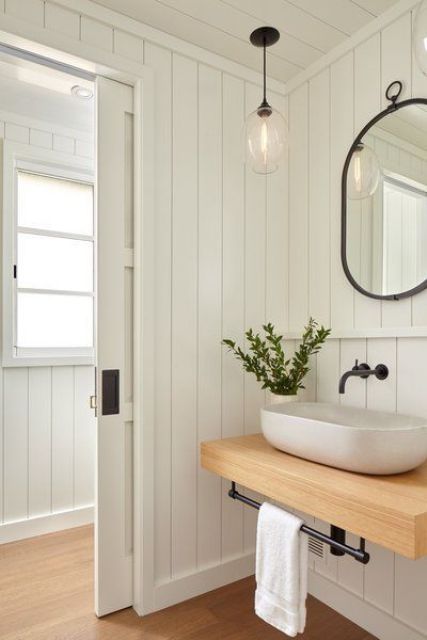 a white farmhouse bathroom with planked walls, a floating vanity and a rounded vessel sink for a chic look and black touches Farmhouse Powder Room, Vertical Shiplap, Mirror Interior Design, Shiplap Wall, Glenwood Springs, Powder Room Design, Cottage Bathroom, Wall Bathroom, Floating Vanity