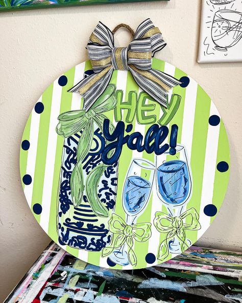 New door hanger!! Absolutely love all of the greens and blues 💚🤩🦋🩵🫶🏼 #doorhanger #drinks #art #artwork #paint #art #artwork #artist #apartment Door Hanger Bows, Door Hangers Wooden, Sorority Paintings, Circle Door Hanger, Preppy Painting, Circle Door, Bow Door, Door Painting, Painted Wooden Signs