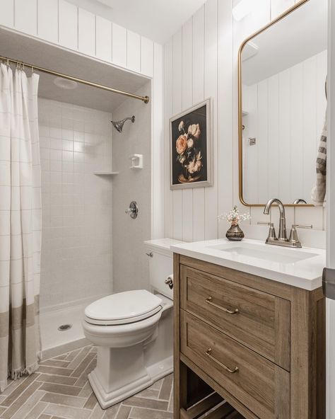 This cute guest bath was part of a large first floor renovation and we decided early on that we wanted the bathroom to look nice, but without breaking the bank because other rooms were much higher on the priority list. We focused the dollars on a new vanity with storage, shiplap to give visual interest and an affordable floor tile in a fun herringbone pattern. We saved by keeping the existing shower insert since it rarely gets used, and a fun curtain would hide it anyway. We find more often... Bathroom Shower Insert, Tile Around Bathtub, Shower Inserts, Floor Renovation, Herringbone Tile, Vanity Storage, Shower Kits, Board And Batten, Guest Bath