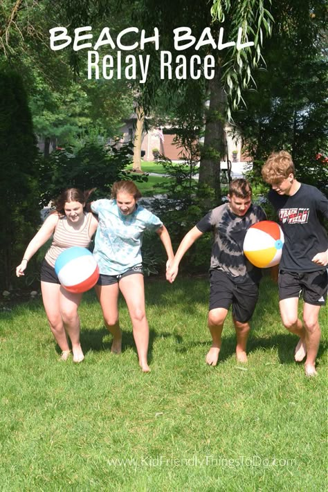 This Beach Ball Relay Race outdoor game is a blast to play. Perfect for large groups, youth groups, summer games, and backyard fun. www.kidfriendlythingstodo.com Outdoor Games For Large Groups, Camping Yard Games, Outdoor Family Games Relay Races, School Relay Race Ideas, Bible Outdoor Games, Family Outdoor Games Backyards, Large Group Relay Games, Backyard Relay Games, Relay Games For Family Reunions