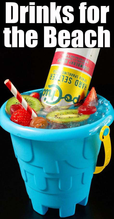 A blue plastic sand bucket is filled with ice and a cocktail that's topped with sliced kiwis, gummy candy, sliced strawberries, and a Topo Chico hard seltzer. Summer Beach Drinks, Drink On The Beach, Bay Breeze Cocktail, Ideas For The Beach, Bartender Drinks Recipes, Fun Drink Recipe, Beach Pail, Tropical Cocktails, Spicy Drinks