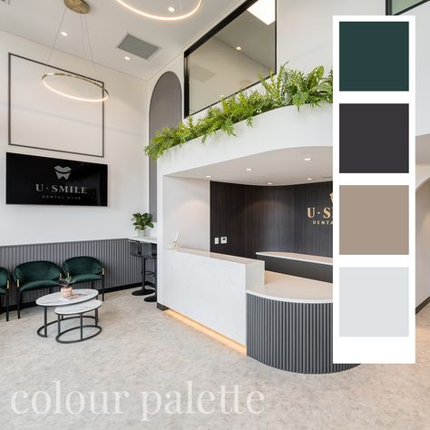 The grand, double-height entrance emphasises the uniqueness of this fitout by harnessing the sense of space and light, while soft touches of greenery and wall panelling bring a more human scale and feeling of approachability. #dentist #dentalclinic #dentistdesign #elegant #brown #beige #colourpalette #greenery #interiordesign #interior #emerald #green #lightdesign #bulkhead #reception #clinic #healthcarespace #dentaloffice Green Dental Clinic, Dental Clinic Reception Design, Reception Clinic, Dental Clinic Logo, Dental Logo Design, Human Scale, Dental Office Design Interiors, Clinic Interior, Clinic Logo