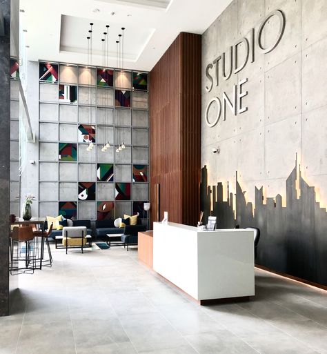 Studio One is one of the latest developments here in Dubai & it just opened it doors to its residents - designed & furnished by @EMDE_Design #urban #modern #lobby #lobbydesign #design #concrete #artwork #decor Interior Design Urban Modern, Corporate Office Entrance Design, Open Office Wall Design, Corporate Office Lobby Design, Building Lobby Design Entrance, Reception Wall Design Modern, Office Back Wall Design Interiors, Office Reception Wall Design, Modern Entrance Lobby Design Residential