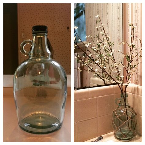 Before and After project of the day! So excited with how it turned out! Up-cycled an old glass wine bottle (Carlo Rossi ... Because it's unbelievable according to my husband)use some twine and a lil bit of patience to create a fisherman's net around the bottle using a technique I found from Kristi at the Wayfair blog. Then I just borrowed some faux flower stems from another vase around the house and Viola! Instant Awesomeness!! P.S. It's gonna turn into a lamp soon just need to get the hardware! Wine Jug Decor, Glass Gallon Jugs Ideas, Glass Jugs Crafts, Glass Jugs Decor, Wine Jug Crafts, Jug Decor, Wine Jug, Bottle Ideas, Glass Bottles Art