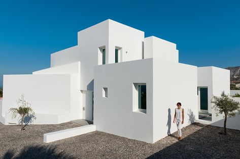 “The summer house is located at the edge of the Messaria village in Santorini. The square-shaped plot with a small inclination faces northeast to the sea and south to the village of Pirgos and the mountain. The building consists of a ground floor, upper floor and a small storage space in the basement.  A central internal staircase connects and unifies visually the individual floor levels. The exterior space, around the building, is formed with sitting, dinning and planting areas.” Greek Homes, Greece House, Santorini House, Funny Real Estate Quotes, Funny Real Estate, Greek Villas, Mediterranean Architecture, Minimal House Design, Real Estate Quotes