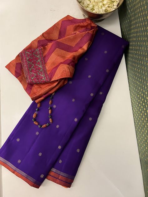 Introducing a fresh addition to our charming collection from the Vera range: a breathtaking pure handwoven Kanchipuram saree featuring a vivacious violet body complemented by an orange-shaded pure zari border and a delightful pallu with zari stripes. This exquisite piece showcases a vibrant color palette that steals the spotlight. The pure zari motifs are contemporary yet yield a traditional touch to the drape. With numerous styling options, this saree effortlessly transitions from intimate family gatherings to grand weddings. Designer Kanchipuram Silk Saree, Unique Saree Colour Combinations, Orange Saree Blouse Combination, Stripes Blouse Designs, Isha Borah, Benaras Sarees, Kancheepuram Silk Saree, Saree Color Combinations, Katan Saree