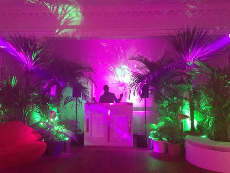 DJ booth set in jungle themed party. Jungle Dj Booth, Techno Theme Party, Neon Jungle Party Decorations, Dj Booth Decoration, Tropical Dj Booth, Neon Dj Booth, Techno Party Decoration, Dj Themed Birthday Party, Neon Jungle Aesthetic