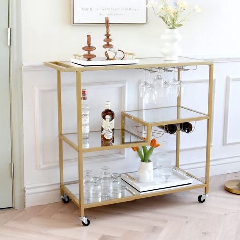 PRICES MAY VARY. Large Size, Great Joy: Sized 15.75”D x 39.5”W x 37.75”H, this 3-tier bar cart offers spacious room for your bar essentials. Whisky, gin, and rum...put all your favorite drinks on Keep �‘em Safe and Fresh: Delicate stemware? Wines that require to be stored flat? No worries. With 3 rows of glass holders and wine holders, they’ll be well cared for here before your next romantic dinner Roll or Stay: Roll it where your party needs it, or park it next to your sofa to serve coffee after Bar Cart Ideas, Mirror Bar, Cloth Frame, Apartment Bar, Wine Cart, Bar Serving Cart, College Apartments, Gold Bar Cart, Bubbly Bar