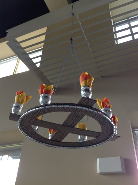 VBS Kingdom Rock. Chandelier made from a hula hoop, cardboard, Gatorade bottles, paper napkins, marker, yarn and aluminum tape. Mighty Fortress Vbs, Medieval Decorations, Medieval Vbs, Medieval Chandelier, Kingdom Rock Vbs, Castle Vbs, Kingdom Vbs, Gatorade Bottles, Medieval Theme