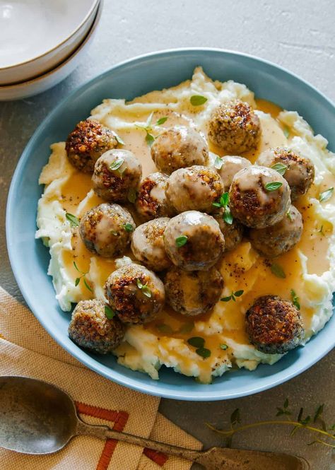 This Meatless Swedish Meatballs over Mashed Potatoes and Gravy is a perfect meatless Monday type of dish. The mushroom meatballs are ‘meaty’, and really flavorful in general. They’re also pretty easy to make and freezer friendly! | dinner recipes | healthy dinner recipes | meatball recipes | vegetarian recipes | vegan recipes | Meatballs Over Mashed Potatoes, Vegan Swedish Meatballs, Mashed Potatoes And Gravy, Potatoes And Gravy, Meatless Meatballs, Over Mashed Potatoes, Vegan Meatballs, Flavorful Vegetables, With Mashed Potatoes