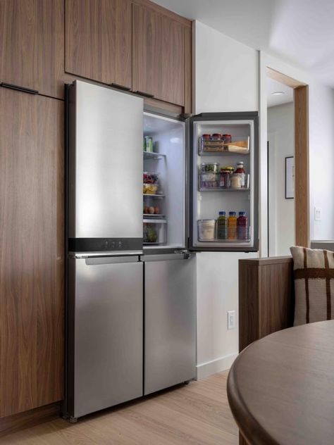 Groceries are easy to restock with the stainless steel fridge that blends in perfectly to the kitchen's modern, minimalist design. Kitchen With Stainless Steel Refrigerator, Silver Fridge Kitchen, Kitchen Fridge Ideas, Hgtv Kitchens, Home Bar Essentials, Clever Kitchen Storage, Kitchen 2024, Refrigerator Cabinet, Stainless Steel Fridge