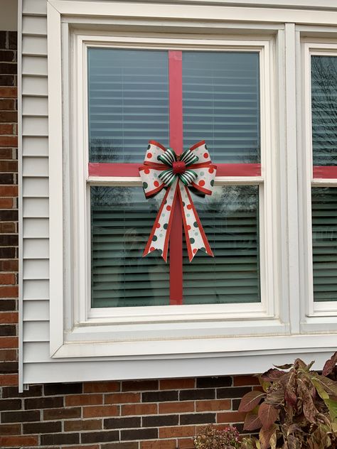 Christmas window decorating. This worked great this year. Held on with packing tape. Bow from Joannes. Used led tape lights around edge of window in warm white. Used on inside facing out. Didn’t use the adhesive on back but used packing tape to stick them on. They lay perfectly straight. Window Bows Christmas, Christmas Bow Window Decorations, Bows On Windows Christmas, Christmas Bows On Windows, Outside Window Christmas Decor Ideas, Window Christmas Decor Ideas Outdoor, Christmas Decor For Windows Inside, English Christmas Traditions, Christmas Decir