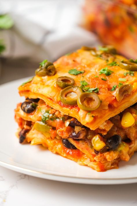 Loaded with meaty goodness, beans, corn, olives and more, Mexican Tortilla Lasagna is a tasty twist on the Italian classic! Mexican Lasagna With Tortillas, Tortilla Lasagna, Mexican Tortilla, Hispanic Recipes, Most Pinned Recipes, Mexican Lasagna, Night Recipes, School Recipes, Mexican Casserole