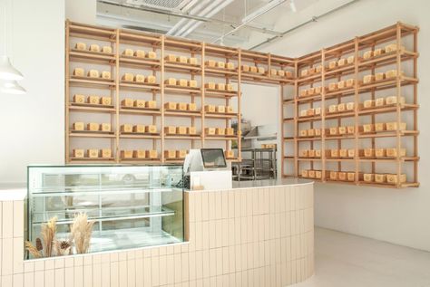 White bread loaves on display at Whitelier bakery Korean Bakery, Design Anthology, Bakery Store, Light Colored Wood, Beige Tile, Retail Design Blog, Wooden Beams, White Bread, Architectural Features