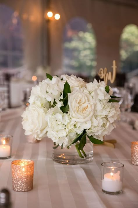 White Roses In Glass Vase, Low White Rose Centerpiece, One Vase Wedding Centerpiece, Small Centerpieces With Candles, Small White Centerpieces Simple, White Rose Bouquet Centerpiece, Black Gold And Ivory Centerpieces, Simple Hydrangea Centerpiece Wedding, Round Flower Centerpieces