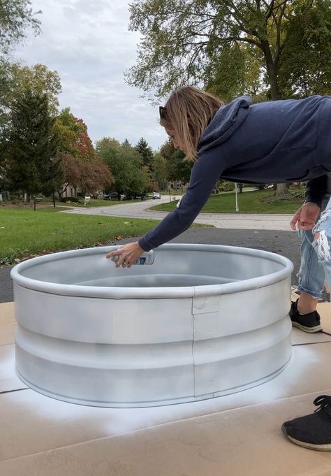 Melissa Tyler spraying a metal firewood rack with white Rustoleum primer. Diy Wood Holder Outdoor, Diy Firewood Storage Outdoor, Diy Firewood Holder, Metal Fire Pit Ring, Metal Firewood Rack, Firewood Storage Ideas, Diy Firewood Rack, Firewood Storage Outdoor, Outdoor Firewood Rack