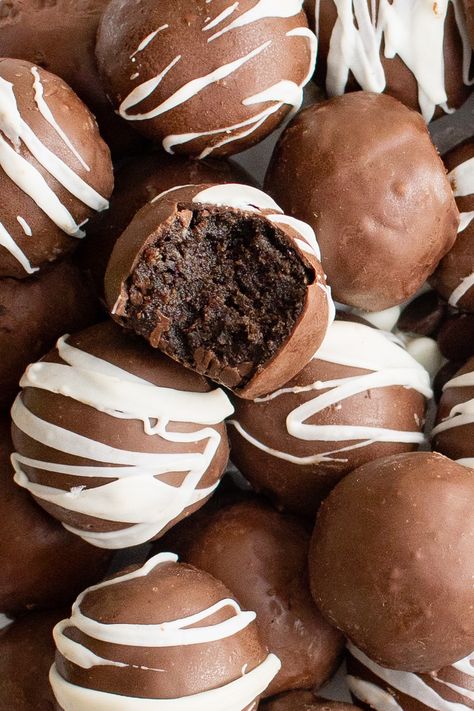 These rich and creamy Brownie Truffles are made with your favorite brownie mix or homemade brownie recipe then mixed with cream cheese and peanut butter. Cover them in rich chocolate to make the perfect sweet treat that the whole family will love!