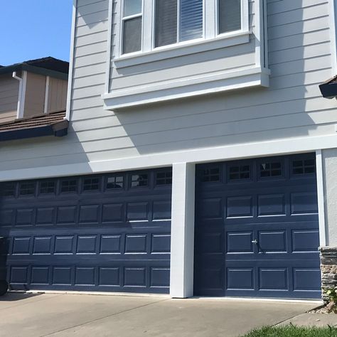 We're loving the contrast of this navy blue garage door 🔷  What is your dream color combo?  Contact the team at Timmins to get your residential #paintjob started today. The first step is to schedule your FREE estimate! Navy Blue Garage Door, Blue Garage Door Exterior Colors, Navy House With Wood Garage Door, Navy Blue House Exterior White Trim Garage Doors, Navy Garage Door, Blue Garage, White House Blue Garage Door, Dark Blue Garage Door, Gray House Blue Garage Door