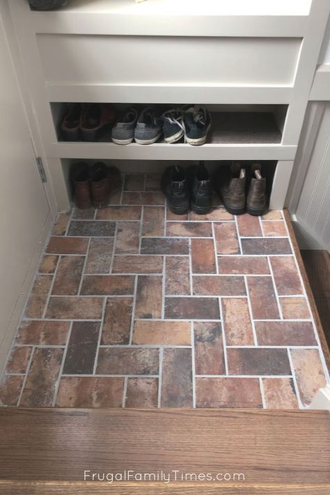 Wish you had space for a mudroom?You just might! We made an organized entryway mudroom space in a tiny stair landing! A built in mudroom may be your entryway storage solution too. We focused our DIY skills onadding a mudroom in a small space - and we've small mudroom ideas for you too! Small Space Shoe Entryway Mudroom, Understairs Entryway, Small Entryway Tile Ideas, Landing Tile Ideas, Small Entry Way Flooring Ideas, Small Entrance With Stairs, Tiny Entryway With Stairs, Entryway Carpet Front Doors, Between The Studs Entryway Built Ins