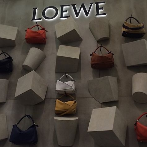 LOEWE @theofficialselfridges #puzzlebag by Zurvita Zeal Wellness Visual Merchandising Displays, Jonathan Anderson, Window Display Design, Retail Inspiration, Retail Windows, Bag Display, Concrete Art, Exhibition Display, Retail Store Design