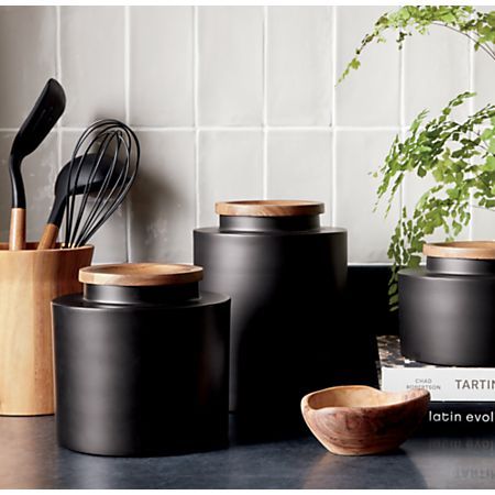 Clark Large Matte Black Canister + Reviews | Crate and Barrel Black And Wooden Kitchen Accessories, Manly Kitchen Decor, Kitchen Counter Containers, Black Canisters For Kitchen, Black And Wood Kitchen Decor, Kitchen Decor Inspiration Modern, White And Black Kitchen Decor, Black Decor Kitchen, Black And Tan Kitchen