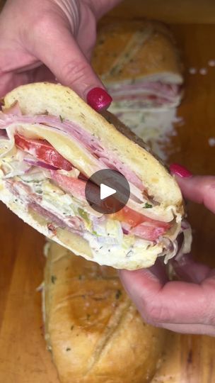 886K views · 14K reactions | The chokehold this sandwich has had me in for the last 2 years! 😭 It’s so dang good! The dressing is mayonnaise, submarine sauce, (or you can use olive oil, red vinegar and Italian seasoning), with sliced lettuce, sliced red onions, chopped banana pepper rings, chopped pickles and fresh grated parmesan! For the sandwich,  I brushed the bread with melted butter mixed with minced garlic, freshly grated parmesan and dried parsley. Baked it for about 5 minutes at 400 degrees. Topped with ham, turkey, salami and pepperoni and provolone cheese. Baked another 5 minutes. Put it all together then brushed the top with more of the butter mixture and baked another 5 minutes! So freaking good! This all cost roughly $25 and it fed 4 people! 😋 #sandwich #grinder #subsandwic Sub Dressing Recipe, Sandwich Grinder, Banana Pepper Rings, Pepper Rings, Grinder Sandwich, Sandwich Sauces, Italian Sandwich, Dried Parsley, Cheese Baked