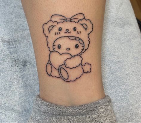 Hello Kitty Best Friend Tattoo, Hello Kitty Lower Back Tattoo, Teddy Bear Heart Tattoo, Hello Kitty And Friends Tattoo Ideas, Cute Kawaii Tattoos Small, Bear Holding Flowers Tattoo, Hello Kitty Ankle Tattoo, Hello Kitty Arm Tattoo, Hello Kitty Chest Tattoo