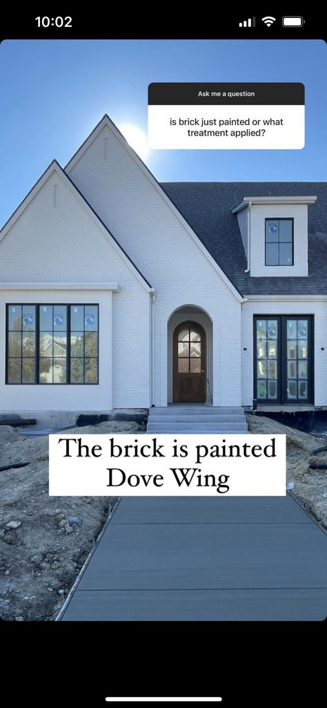 White Brick House With Black Accents, German Schmear Brick Exterior Black Windows, White Brick And Rock Exterior, White And Brick House Exterior, White Painted Brick With Brown Roof, White Brick House With Dormers, Cream Colored Painted Brick Houses, Dover White Brick Exterior, Painted Brick And Siding Exterior