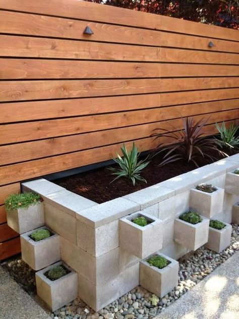 A cinder block garden bed can turn any outdoor space into a serene oasis. The clean lines and sturdy structure of the blocks provide a modern touch, while the natural beauty of the plants adds a calming effect. This fusion of form and function ensures a low-maintenance, visually appealing garden that invites relaxation. Bloxburg Basement, Cinder Block Garden, Cave Basement, Modern Front Yard, Cinder Blocks, Small Front Yard Landscaping, Kids Basement, Front Yard Design, Garden Area