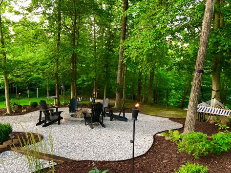 Wood Backyard Ideas, White Farmhouse Landscape Ideas, Backyard Picnic Area, Fire Pit In Middle Of Yard, Outdoor Seating Area Fire Pit Corner Yard, Cabin Landscape Ideas, Outdoor Hangout Area Woods, Backyard Ideas With Fire Pit Sitting Areas Back Yard, Pebble Fire Pit Area