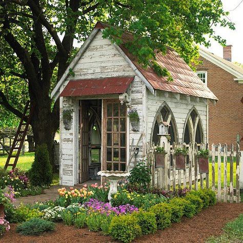 Gothic arched windows add to the antique feel of this garden shed. Stamped-metal roofing and hanging planters on the fence repeat the arched shape. A row of boxwoods brings order and definition to the entry garden. Shed Inspiration, Shed Decor, Gothic Garden, Backyard Vegetable Gardens, Garden Wallpaper, Backyard Sheds, Backyard Shed, Potting Sheds, She Sheds