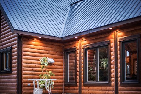 This is the best! Different and contrasting stain colors look absolutely fantastic. Very classy log home! Log Cabin Exterior Lighting, Log Home Exterior Colors, Cabin Exterior Colors, Exterior Cabin, Log Homes Exterior, Black Metal Roof, Log Cabin Exterior, Cabin Remodel, Siding Ideas