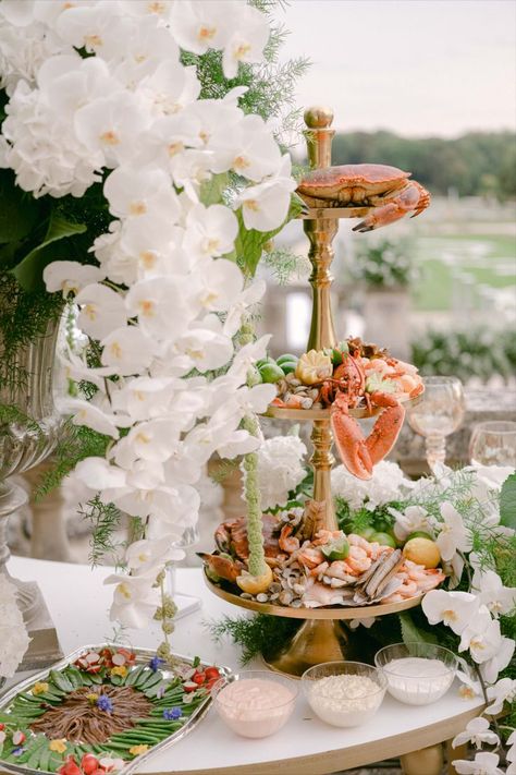 Indulge in luxury with this stunning seafood platter, featuring fresh crab, lobster, shrimp, and shellfish. Presented on a tiered stand, this decadent display is complemented by elegant white orchids, creating a sophisticated and visually striking centerpiece. Perfect for adding a touch of elegance to your wedding or special event. Wedding food, event catering, wedding inspiration, wedding ideas, elegant wedding, wedding planning, wedding reception decor, wedding menu, event catering Orchid Display, Wedding Ideas Elegant, Food Event, Wedding Reception Decor, Seafood Platter, Culinary Art, Planning Wedding, Enjoy Every Moment, Tiered Stand